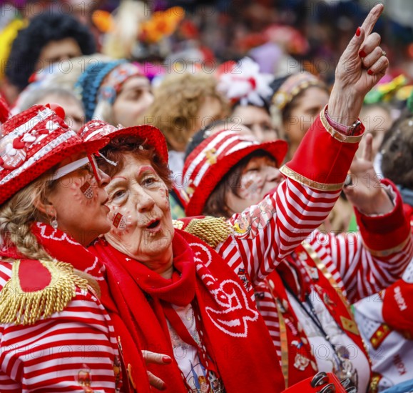 Colourfully costumed carnivalists celebrate carnival in Cologne, on Weiberfastnacht the street carnival is traditionally opened on the Alter Markt, which then reaches its climax on Rosenmontag, Cologne, Rhineland, North Rhine-Westphalia, Germany, Europe