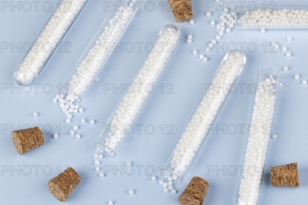 Test tubes with dropped globules and corks on a blue background
