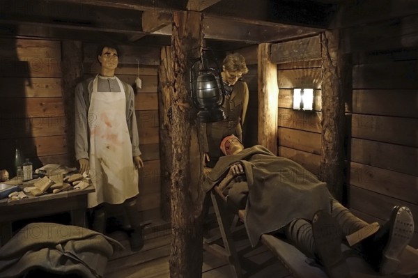 Diorama of WWI British almoner and doctor treating wounded soldier in dugout of WW1 trench at Passchendaele Museum, Zonnebeke, West Flanders, Belgium, Europe