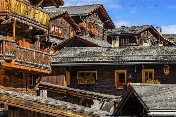 Old wooden houses decorated with flowers in the historic village centre, Grimentz, Val d'Anniviers, Valais Alps, Canton Valais, Switzerland, Europe