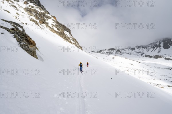 Two ski tourers in a wintry mountain landscape, ascent to Piz Laviner, Grisons Haute Route, Albula Alps, Rhaetian Alps, Grisons, Eastern Switzerland, Switzerland, Europe