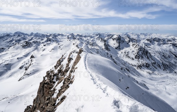 Tracks in the snow on a narrow mountain ridge in winter, summit of Piz Grialetsch, view of mountain panorama with snow, Grisons Haute Route, Albula Alps, Rhaetian Alps, Grisons, Switzerland, Europe