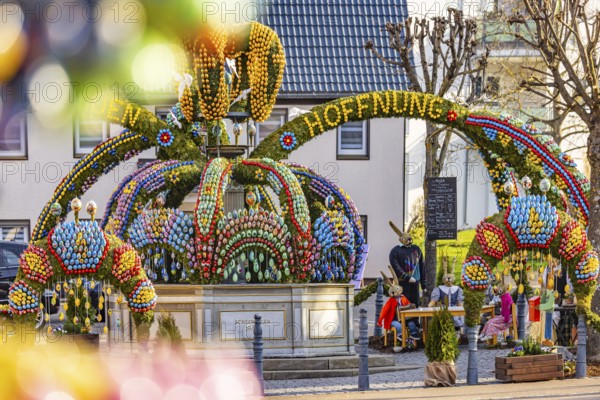 The Easter fountain in Schechingen has around 13, 000 hand-painted eggs. This makes it one of the largest and most beautiful in the whole of East Württemberg. Around 50, 000 visitors admire the decorated village fountain every year. Schechingen, Ostalbkreis, Baden-Württemberg, Germany, Europe