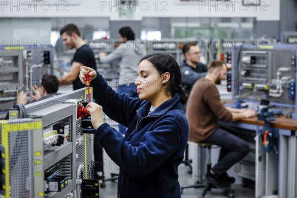 Remscheid, North Rhine-Westphalia, Germany - Trainee woman in electrical professions, an industrial electrician assembles a circuit, Vocational Training Centre of the Remscheid Metal and Electrical Industry. - FOR EDITORIAL USE ONLY!