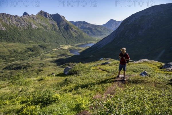 Mountaineers on a hiking trail to the summit of Rundfjellet, mountain landscape and valley with lakes, near Austnesfjord, Svolvaer, Nordland, Norway, Europe