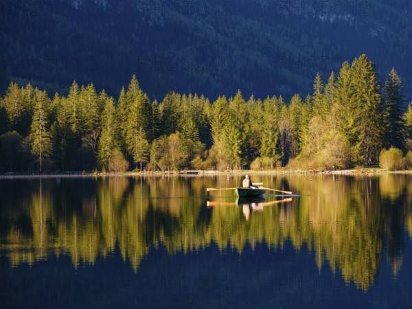Angler in a rowing boat on the Hintersee in the first sunlight, Berchtesgaden National Park, Ramsau, Berchtesgadener Land, Upper Bavaria, Bavaria, Germany, Europe
