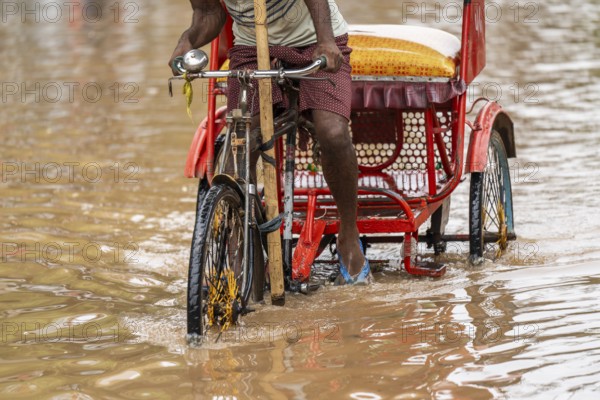Commuters wade through a flooded street after heavy rains in Guwahati, India on April 28, 2025