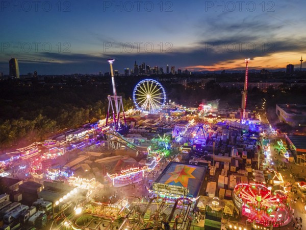The lights of the Dippemess in Frankfurt am Main glow after sunset. Aerial view, ice rink, Frankfurt am Main, Hesse, Germany, Europe