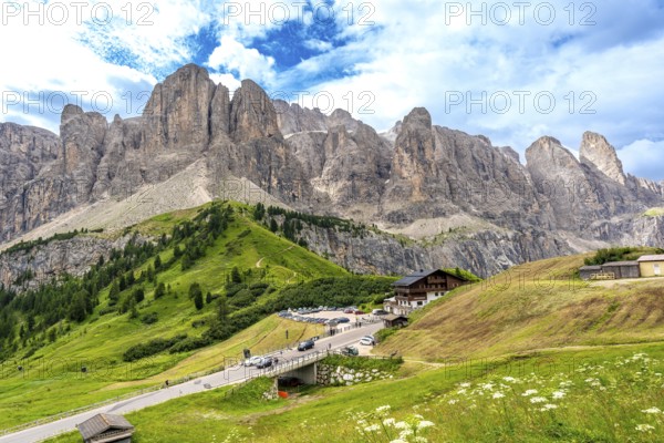 Breathtaking landscape showing the winding road of passo gardena and the majestic mountain range of the dolomites in summer, italy