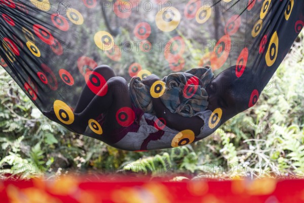 A child of tea plantation worker underneath a tent as mothers pluck tea leaves at the Tea Estate on April 2, 2025 in Bansbari, Assam, India, Asia