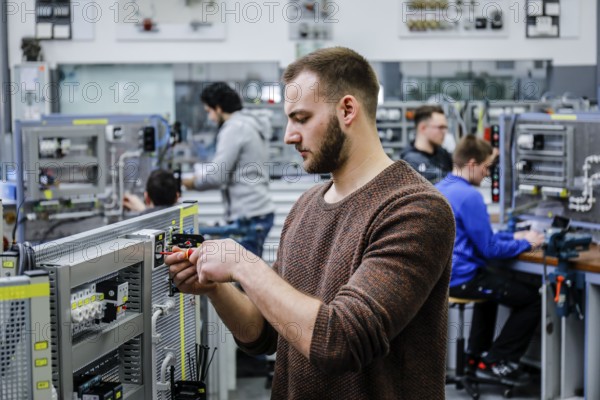Remscheid, North Rhine-Westphalia, Germany - Trainees in electrical professions, an industrial electrician assembles a circuit, Vocational Training Centre of the Remscheid metal and electrical industry. - FOR EDITORIAL USE ONLY!