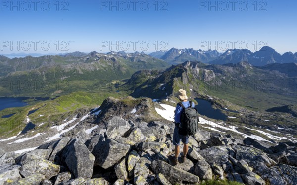 View of mountains and fjord landscape, mountain panorama, mountaineer at the summit of Rundfjellet, lake Hellskarvatnet, Svolvaer, Nordland, Norway, Europe