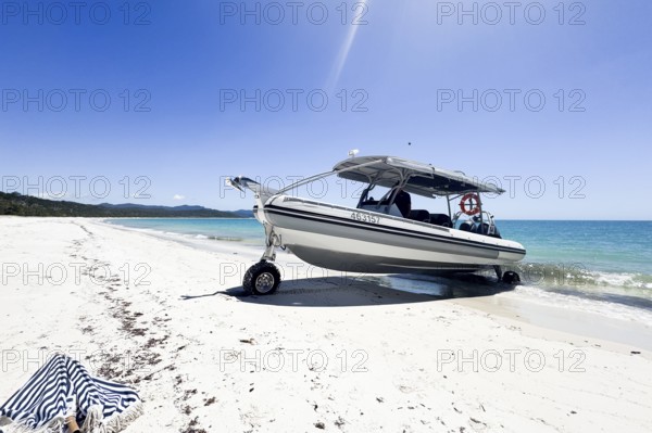 Boat on wheels standing at unique famous Whitehaven Beach. Modern amphibious boat capable to drive on land, beach. Whitehaven Beach, Whitsundays National Park, Great Barrier Reef, Queensland, Australia, Oceania