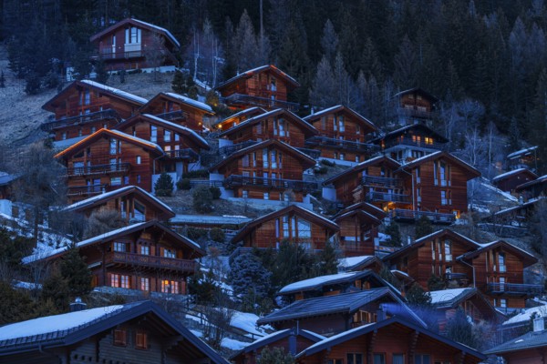 Chalets built into the hillside as holiday homes at dusk, Grimentz, Val d'Anniviers, Valais Alps, Canton Valais, Switzerland, Europe