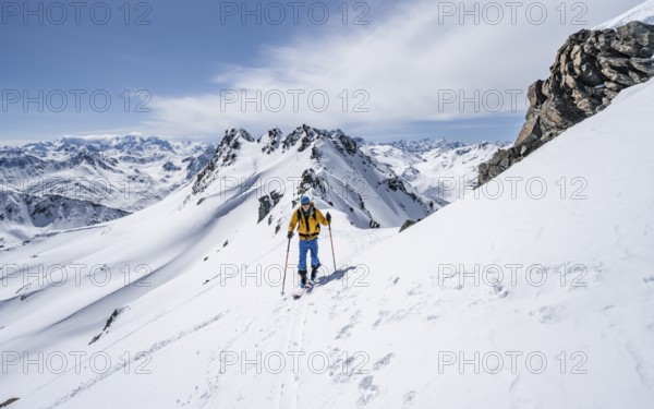Ski tourer on a mountain ridge, mountain landscape with snow, mountain panorama with summit of the Grisons Alps, ascent to the Scalettahorn, Grisons Haute Route, Albula Alps, Rhaetian Alps, Grisons, Switzerland, Europe
