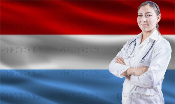 Female doctor on Luxembourg flag. Doctor with crossed arms on Luxembourg flag. Luxembourg health and care concept