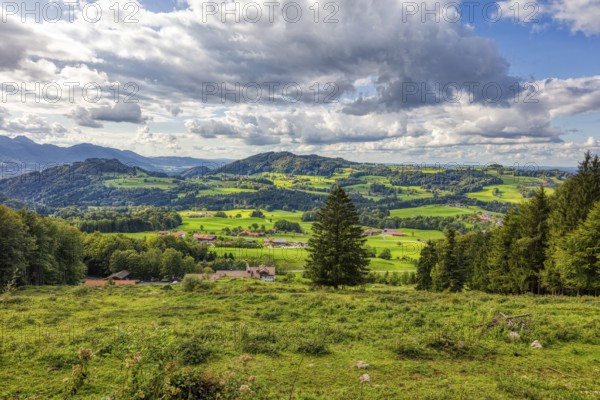 Picturesque mountain landscape with green meadows, wooded hills and impressive clouds in the sky, Doaglalm