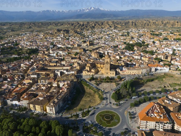 Aerial view of a city with historical centre, roundabout and green parks, surrounded by landscape and mountains in the background, aerial view, Cathedral, Catedral de la Encarnación de Guadix, Guadix, Sierra Nevada, Granada, Andalusia, Spain, Europe