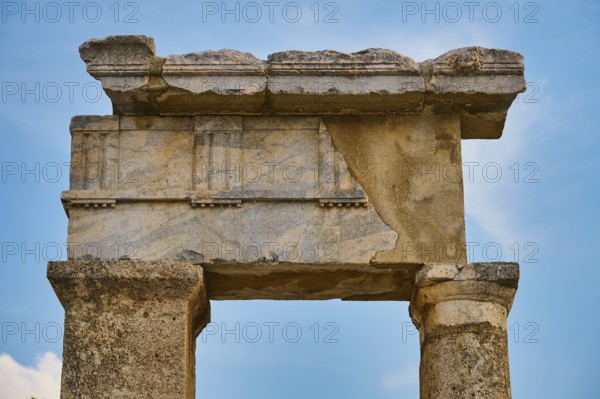 Close-up of an ancient stone gate with fine carvings and blue sky in the background, Well house, Kamiros, Archaeological site, Ancient city, Foundation of Doric Greeks, Rhodes, Dodecanese, Greek Islands, Greece, Europe