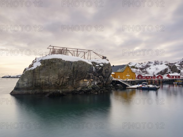 Large rock in the harbour of the authentic fishing village of Nusfjord, Flakstadøya, Lofoten, Norway, Europe