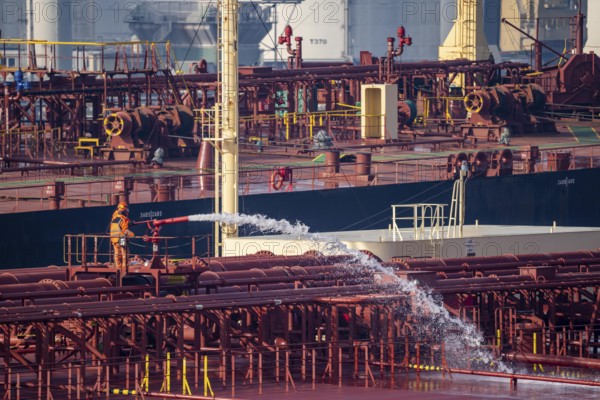 The crude oil tanker HOJO, in the seaport of Rotterdam, in the petroleum harbour, Europoort, ship personnel checking the fire extinguishing equipment, pipelines, Rotterdam, Netherlands