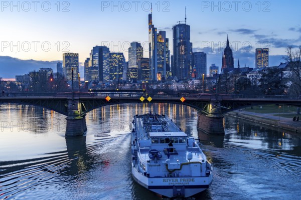 Skyline of the city centre of Frankfurt am Main, river Main, dusk, Ignatz-Bubis-Bridge, cargo ship, tanker, Hesse, Germany, Europe
