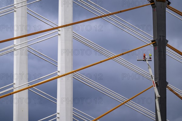 The new Rhine bridge Neuenkamp, the A40, white pillar ropes, and the old motorway bridge, which is being dismantled, preparation for demolition, workers on cherry pickers measure, mark the old bridge pillar, Duisburg, North Rhine-Westphalia, Germany, Europe