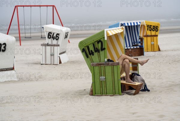 North Sea island Langeoog, early summer, shortly after the first easing of the lockdown in the Corona crisis, foggy weather, still quite few tourists on the beach, beach chairs, Lower Saxony, Germany, Europe