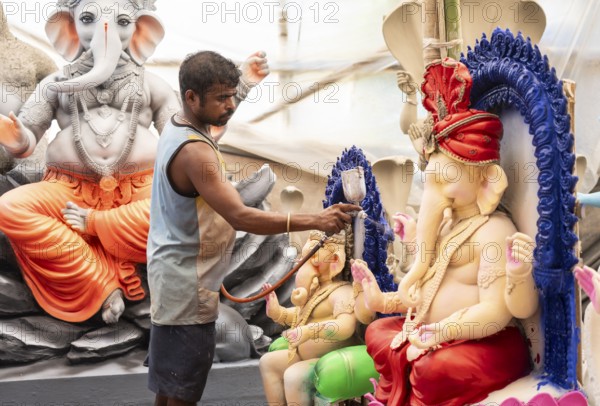 An artisan decorates an idol of the elephant-headed Hindu deity Ganesha at a workshop ahead of the Ganesh Chaturthi festival on September 5, 2024 in Guwahati, Assam, India, Asia