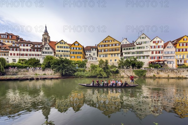 Neckarfront Tübingen with punt on the Neckar. Postcard motif with historic buildings and collegiate church. Tübingen, Baden-Württemberg, Germany, Europe