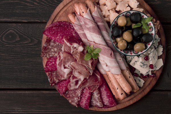 Appetizer, assortment, set, sausage, and cheese, on a wooden board, top view, no people