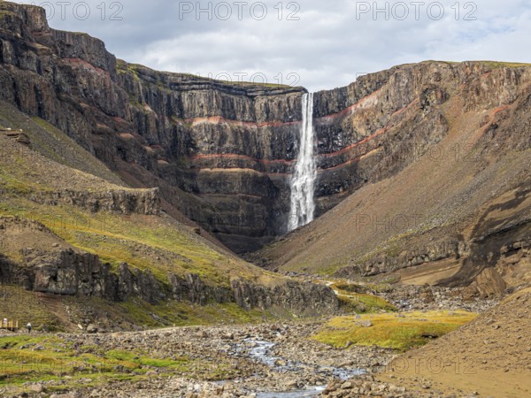 Waterfall Hengifoss, basaltic layers interwoven with red sedimentary layers, Iceland, Europe