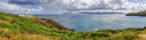 Panoramic view of the sea with a lighthouse and islands under a cloudy sky, Fanad Head Lighthouse