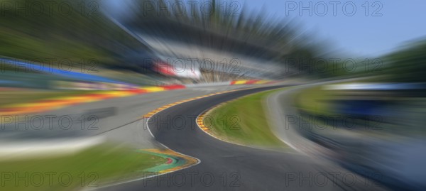 Panorama panoramic photo of Eau Rouge with dynamic speed effect from view tunnel view from racing car perspective of racing driver while driving into dangerous curve Eau Rouge on 40 metres high driveway Raidillon of race track Circuit de Spa Francorchamps, in the background 2022 newly built grandstand for car racing, FIA Formula 1 race track, Circuit de Spa Francorchamps, Ardennes roller coaster, Ardennes, Malmedy, Belgium, Europe