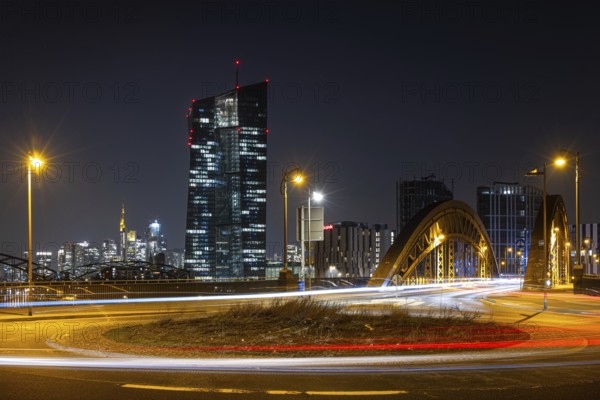 The lights of the European Central Bank (ECB) and the Frankfurt banking skyline glow in the evening, Osthafen, Frankfurt am Main, Hesse, Germany, Europe