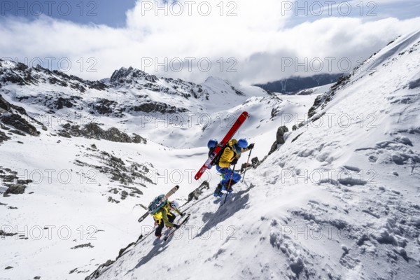 Climbers with skis ascending a steep snow slope to the Porta d'Es-cha saddle, Bündner Haute Route ski tour, Albula Alps, Rhaetian Alps, Grisons, Eastern Switzerland, Switzerland, Europe