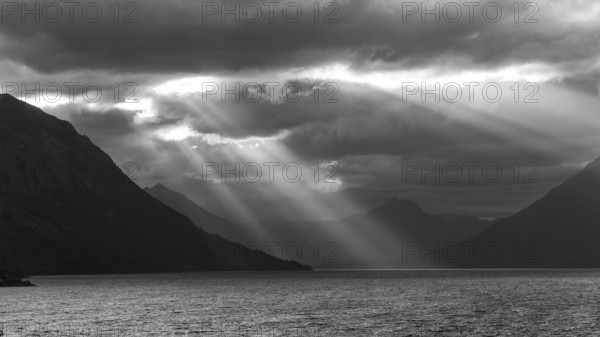Black and white image of sunbeams and light mood at sunset at Lago Huechulafquen, Lanin National Park, Patagonia, Argentina, South America