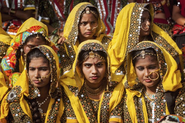 PUSHKAR, INDIA, NOVEMBER 21, 2012: Unidentified Rajasthani girls in traditional outfits prepare for dance perfomance at annual camel fair Pushkar Mela in Pushkar, Rajasthan, India, Asia