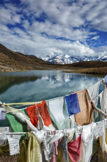 Prayer flags lungta with Om mani padme hum. . mantra written on them and Dhankar Lake. Spiti Valley, Himachal Pradesh, India, Asia