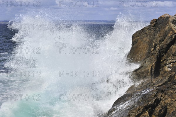 Waves crashing into rocks of cliff along the Brittany coast, France, Europe