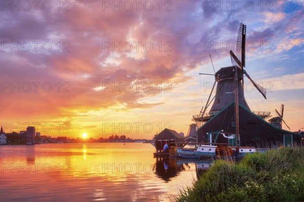 Netherlands rural scene, - windmills at famous tourist site Zaanse Schans in Holland on sunset with dramatic sky. Zaandam, Netherlands