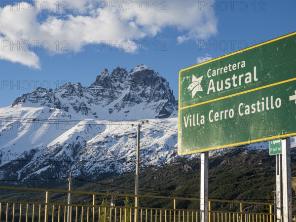 Signpost on road Carretera Austral at Villa Cerro Castillo, snowcapped Mt .Cerro Castillo, Patagonia, Chile, South America