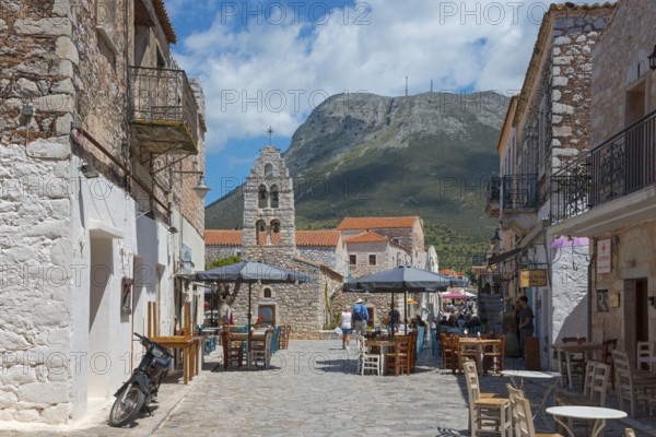 Lively square with church in the background and an impressive mountain backdrop, double church Panagia and Agios Charalambos, Captain Matapa Areopolis Square, Old Town, Areopoli, Areopolis, Tsimova, Itylo, Anatoliki Mani, Mani, Laconia, Peloponnese, Greece, Europe