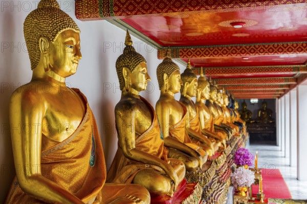 Historic Buddha statues at Wat Pho Temple, sitting, seated, Buddhism, religion, world religion, sculpture, sculpting, art, statue, culture, believing, faith, peace, Asian, travel, holiday, tourism, representation, palace, tradition, traditional, decoration, decorated, house of prayer, building, attraction, landmark, gilded, gold, sacred, pray, meditation, monastery, spirituality, meditate, spiritual, monument, famous, sight, magnificent, philosophy, capital, Bangkok, Thailand, Asia