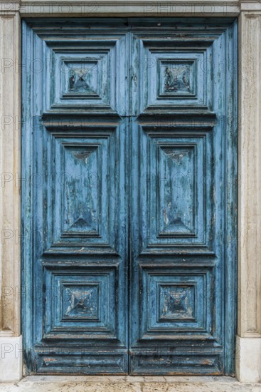 Old blue historic wooden door, dilapidated, withered, peeling, paint, craftsmanship