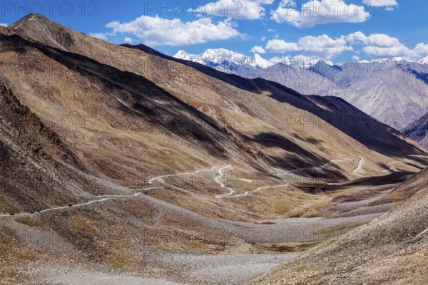 Himalayan valley landscape with road near Kunzum La pass, allegedly the highest motorable pass in the world (5602 m), Ladakh, India, Asia