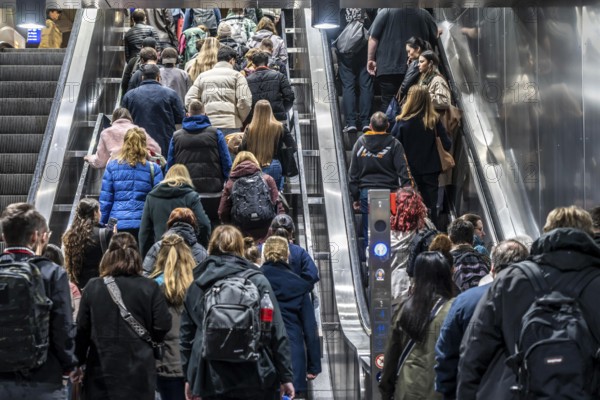 Public transport, underground, main station exit, many people crowding out of the underground station at rush hour in the afternoon, via stairs and escalators, North Rhine-Westphalia, Germany, Europe