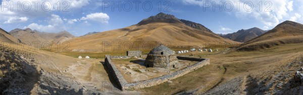 Historic caravanserai Tash Rabat from the 15th century, with yellow hills, Atbashy district in the Naryn region, Kyrgyzstan, Asia