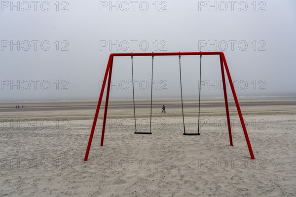 North Sea island of Langeoog, early summer, shortly after the first easing of the lockdown in the Corona crisis, foggy weather, still quite few tourists on the beach, children's swing, Lower Saxony, Germany, Europe