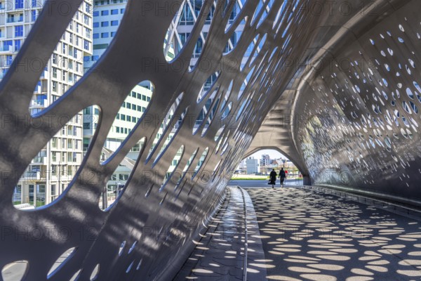 Light effects from the sun in the Parkbruk, a cycle and pedestrian bridge in the city centre of Antwerp, spanning a multi-lane city centre road with tram lines, and thus connecting two lively city districts Kop Spoor Noord and Eilandje, Belgium, without any crossings, Europe